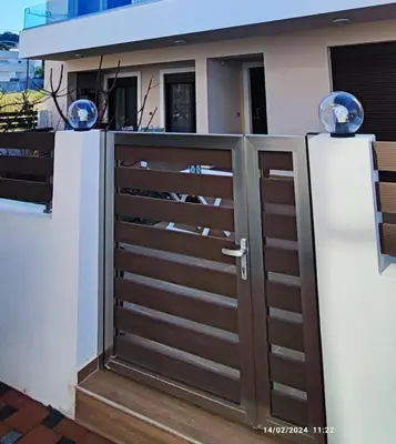 a wooden gate in front of a house at Villa Marina apartment Jasmine in Ixia