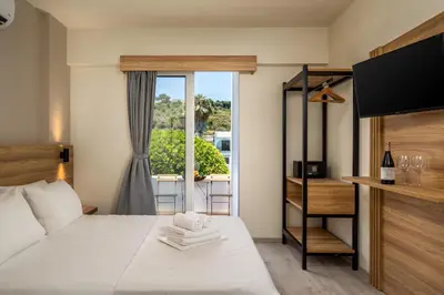 a hotel room with a bed and a window at Colori Di Maria in Afantou
