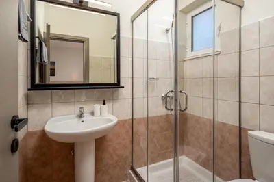 a bathroom with a sink and a shower at Colori Di Maria in Afantou