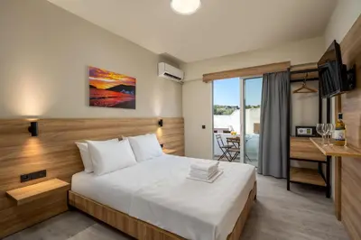 a hotel room with a bed and a desk at Colori Di Maria in Afantou