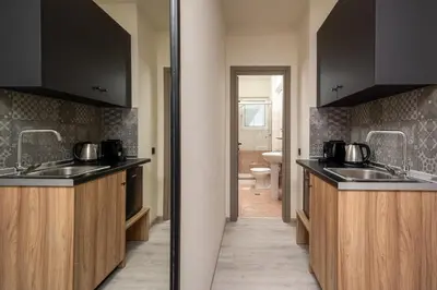 a kitchen with two sinks and a toilet at Colori Di Maria in Afantou