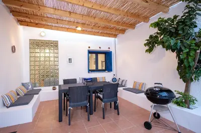 a patio with a table and chairs and a grill at Villa Irini in Kallithea Rhodes