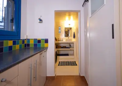 a kitchen with a counter top and a hallway with a door at Villa Irini in Kallithea Rhodes