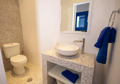 a bathroom with a sink and a toilet and a mirror at Villa Irini in Kallithea Rhodes