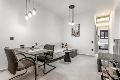 a living room with a couch and a table at Reborn Luxury Apartments in Rhodes Town