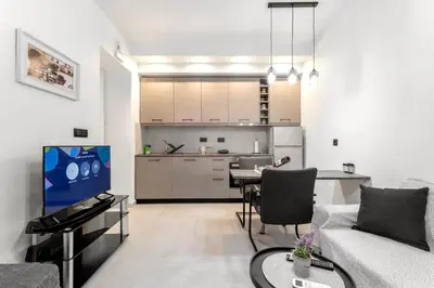 a living room with a couch and a table and a kitchen at Reborn Luxury Apartments in Rhodes Town