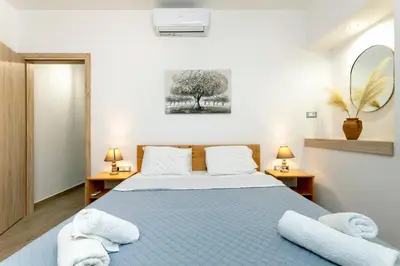 a bedroom with a bed with towels on it at Reborn Luxury Apartments in Rhodes Town