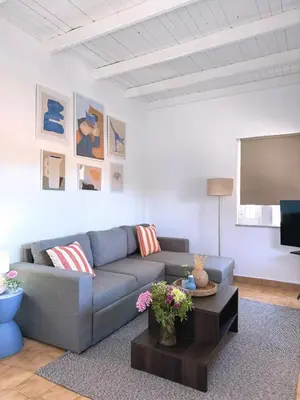 a living room with a couch and a flat screen tv at Nereid Bungalow in Phanaes