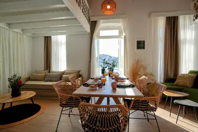 a living room with a wooden table and chairs at Bella Vista in Symi