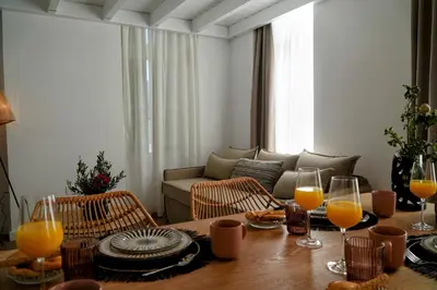 a living room with a table with glasses of orange juice at Bella Vista in Symi
