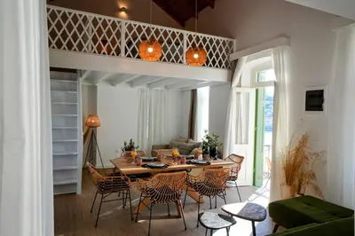 a dining room with a table and chairs at Bella Vista in Symi