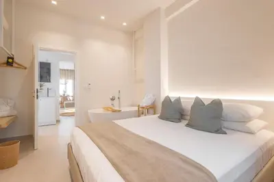 a white bedroom with a large white bed with pillows at The Villa Rhodes Retreat with Private Jacuzzi - Minutes away from Old Town in Rhodes Town