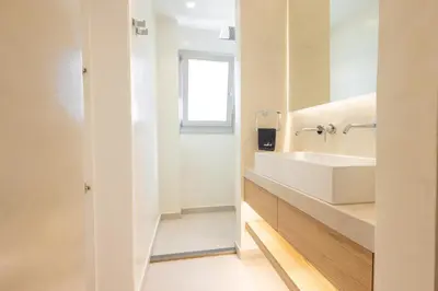 a white bathroom with a sink and a window at The Villa Rhodes Retreat with Private Jacuzzi - Minutes away from Old Town in Rhodes Town