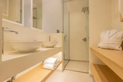 a bathroom with two sinks and a shower at The Villa Rhodes Retreat with Private Jacuzzi - Minutes away from Old Town in Rhodes Town