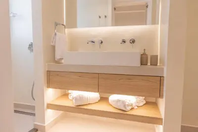 a bathroom with a vanity with a sink and towels at The Villa Rhodes Retreat with Private Jacuzzi - Minutes away from Old Town in Rhodes Town