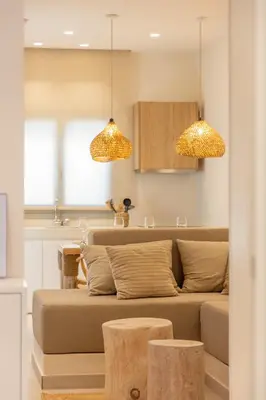 a living room with a couch and two pendant lights at The Villa Rhodes Retreat with Private Jacuzzi - Minutes away from Old Town in Rhodes Town