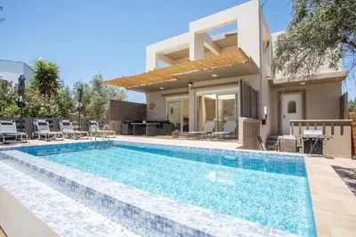 a swimming pool in front of a villa at Villa Frady in Kolimbia
