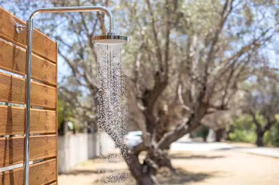 a bird feeder hanging from a fence with a tree at Villa Frady in Kolimbia