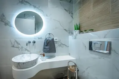 a bathroom with a sink and a mirror at Santa Marina Luxury Apartments #3 in Asgourou