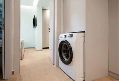 a washer and dryer in a white laundry room at Santa Marina Luxury Apartments #3 in Asgourou