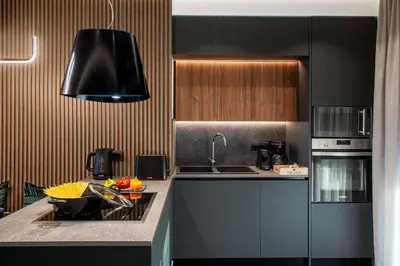 a kitchen with black cabinets and a sink in it at Santa Marina Luxury Apartments #3 in Asgourou