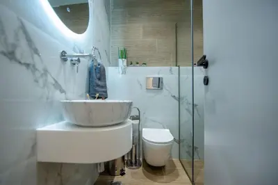 a bathroom with a sink and a toilet and a shower at Santa Marina Luxury Apartments #3 in Asgourou