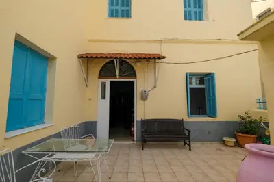 a patio with a table and chairs in front of a building at Archontiko Pataka in Rhodes Town