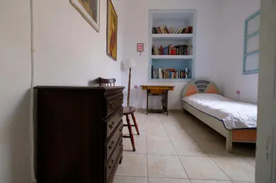 a bedroom with a bed and a dresser with a dresser at Archontiko Pataka in Rhodes Town