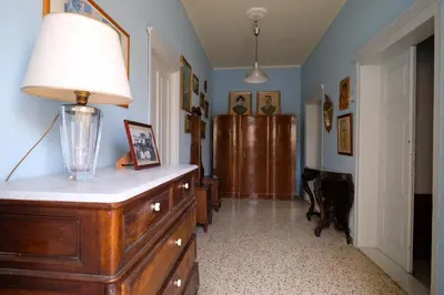 a room with a dresser with a lamp on it at Archontiko Pataka in Rhodes Town