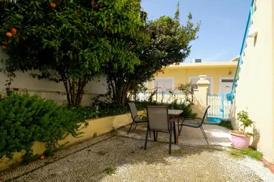 a patio with chairs and a table in front of a house at Archontiko Pataka in Rhodes Town