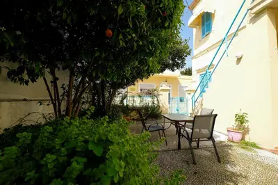 a patio with a table and chairs next to a building at Archontiko Pataka in Rhodes Town