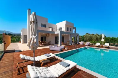 a villa with a swimming pool and a house at Casa Peveragno in Paradeísion