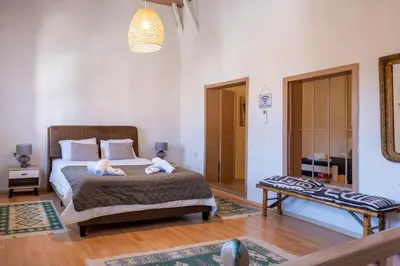 a bedroom with a bed with two stuffed animals on it at George&Michael Traditional House in Rhodes Town
