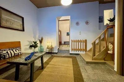 a living room with a couch and a stair case at George&Michael Traditional House in Rhodes Town