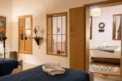 a room with two beds and a mirror at George&Michael Traditional House in Rhodes Town