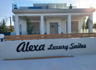aania luxury suites sign in front of a house at Alexa Luxury Suites in Afantou