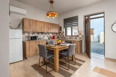 a kitchen with a wooden table and chairs at Παραδοσιακό Κατάλυμα ΑΜΒΩΝΑΣ in Émbonas