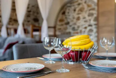 a table with a bunch of bananas in a basket at Παραδοσιακό Κατάλυμα ΑΜΒΩΝΑΣ in Émbonas