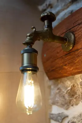 a light hanging from a wall with a light bulb at Παραδοσιακό Κατάλυμα ΑΜΒΩΝΑΣ in Émbonas