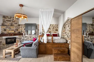 a bedroom with a bed and a fireplace at Παραδοσιακό Κατάλυμα ΑΜΒΩΝΑΣ in Émbonas