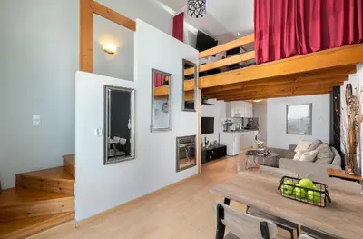 a living room with a table and a couch at Cavo in Ixia