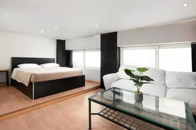 a living room with a bed and a glass table at Cavo in Ixia