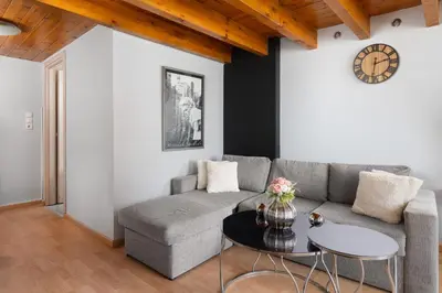 a living room with a couch and a table at Cavo in Ixia