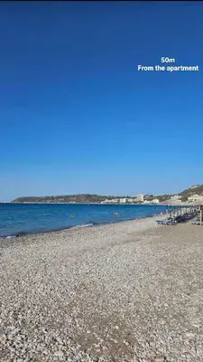 a beach with a pier and the words from the development at Cavo in Ixia