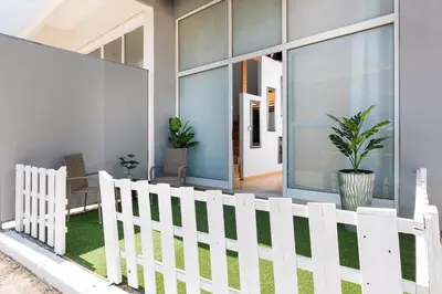 a white picket fence in front of a house at Cavo in Ixia