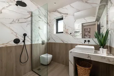 a bathroom with a shower and a sink at Mirena Luxury Living-Mirena Villa in Afantou