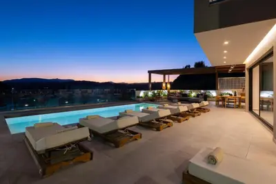 a house with a swimming pool and lounge chairs at Mirena Luxury Living-Mirena Villa in Afantou