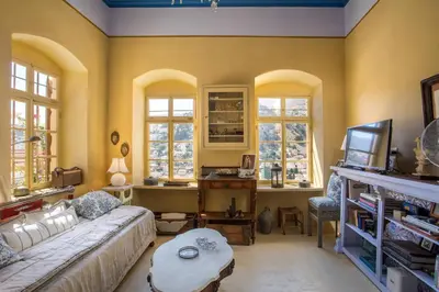 a living room with a couch and a table at kalosymi house,Symi in Symi