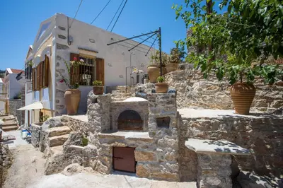 a stone building with an oven in front of it at kalosymi house,Symi in Symi