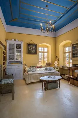 a bedroom with a bed and a blue ceiling at kalosymi house,Symi in Symi